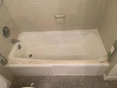 Worn out bathtub with damaged finish before restoration in LA