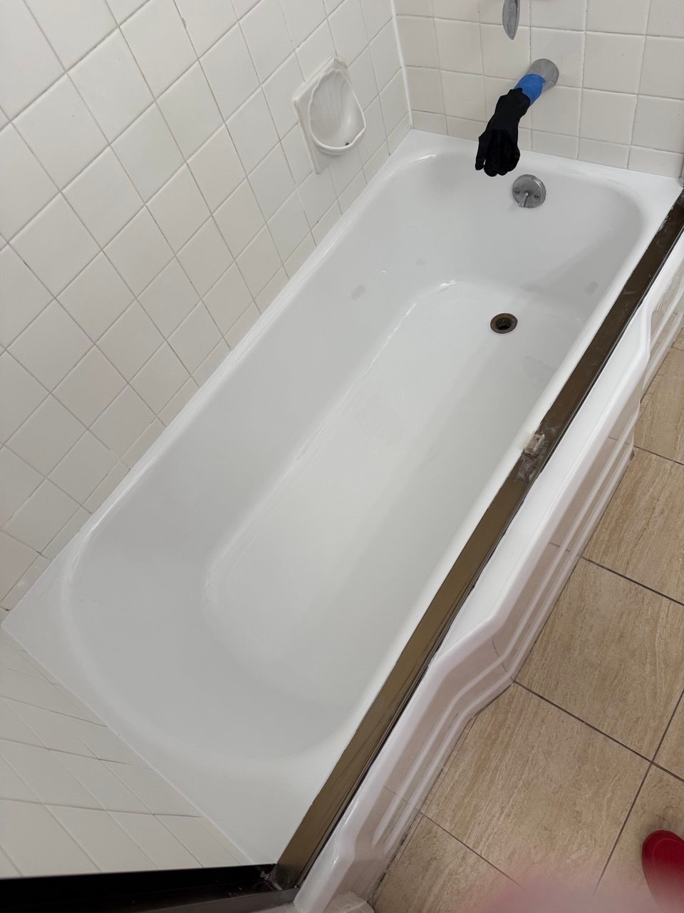 Refinished white bathtub beneath the original Encino wall tile