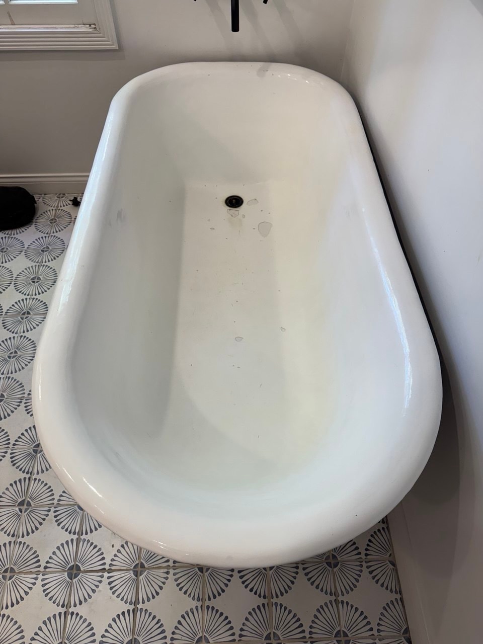 Freestanding bathtub with a worn interior before refinishing in Los Angeles