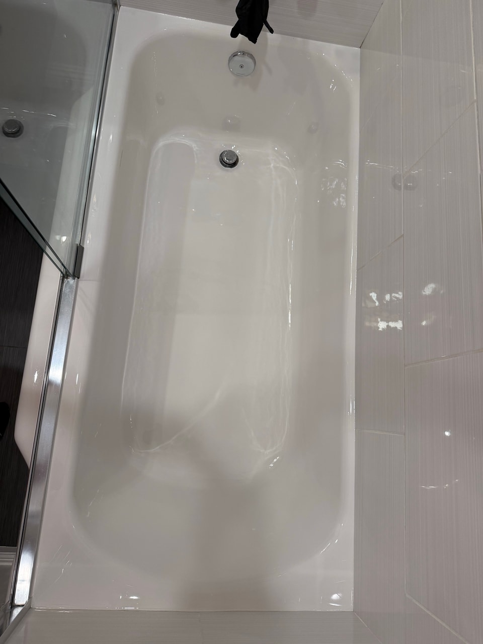 Completed bathtub finish viewed from above toward the drain