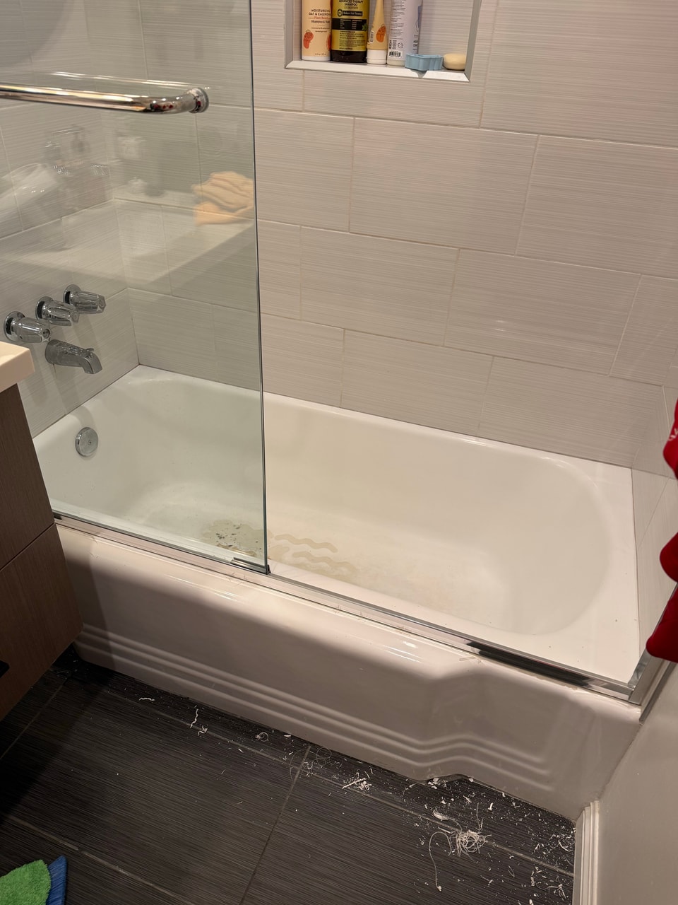 Bathtub and glass enclosure before refinishing in Manhattan Beach