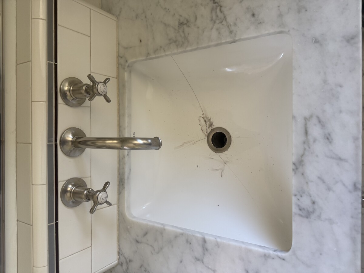 Cracked ceramic sink leaking water