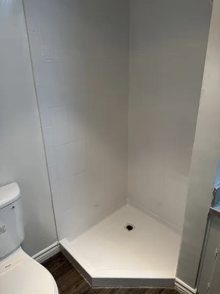 Pristine white refinished bathroom tiles with perfectly sealed grout lines
